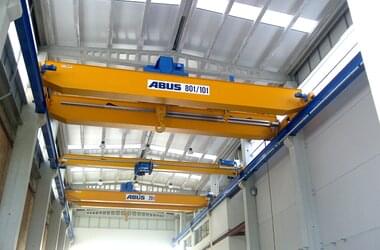 Workshop crane with a load capacity of 80 / 10 t and overhead travelling crane with a load capacity of 20 t in production hall in Spain