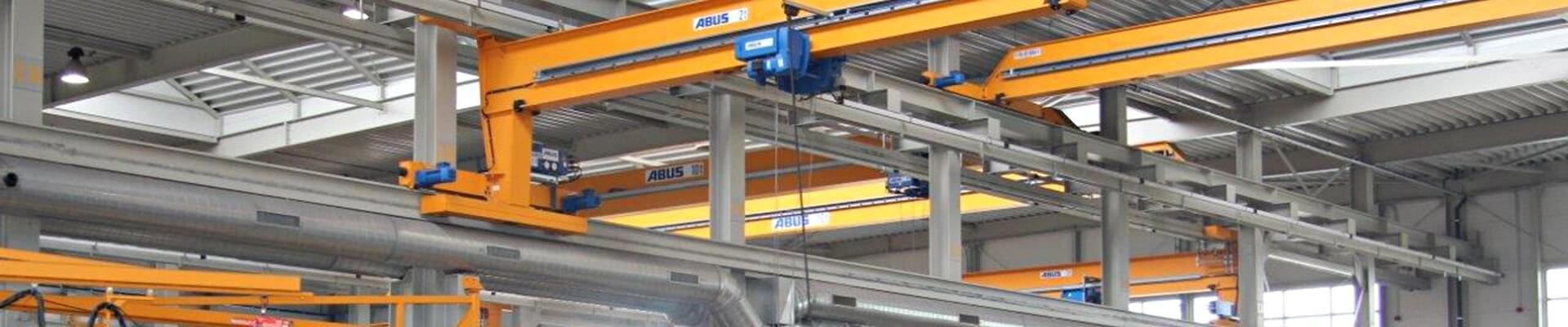 Wall-mounted overhead crane with a trolley in use for construction and serial welding work