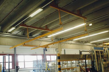 Suspended rail system for in-production window handling