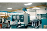 A factory hall with machine tools. An ELV bridge crane with electric wire rope hoist travels on a crane track.