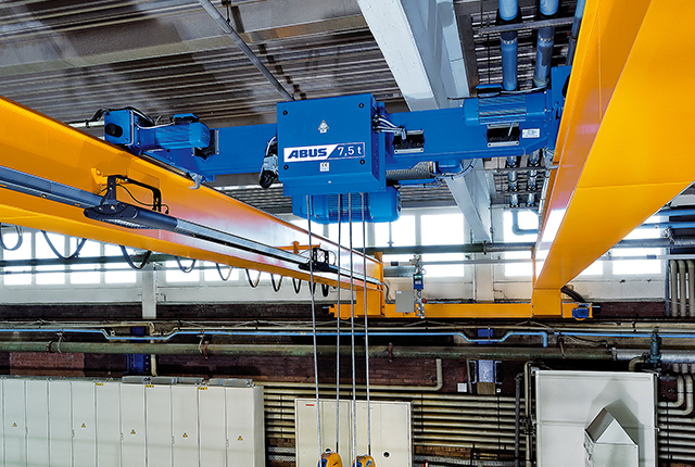 ABUS DA-type double-rail trolley for low headroom and load capacities of up to 40 tonnes in crane systems.